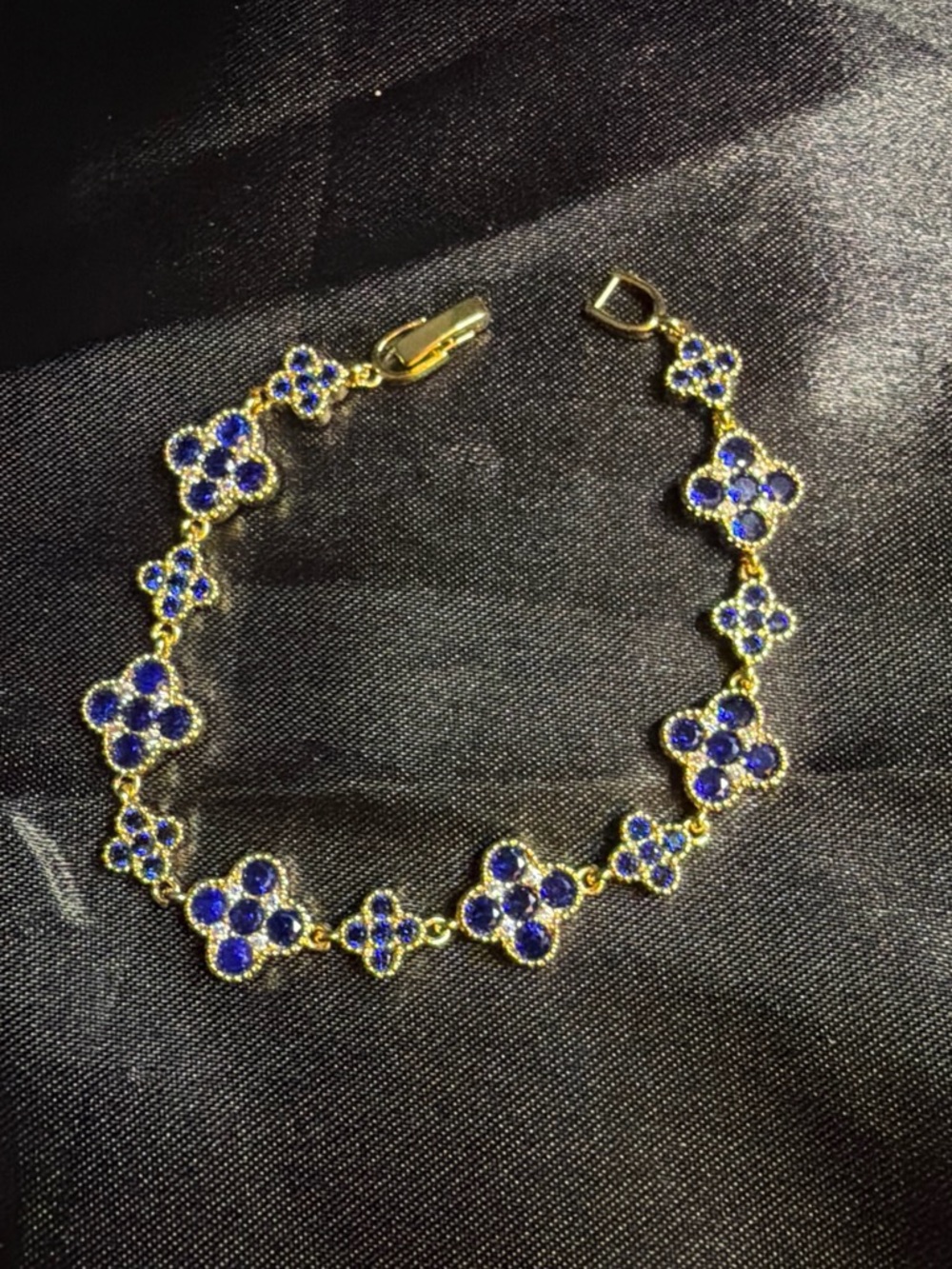 Gold Tone Floral Link Bracelet with Deep Blue Crystals